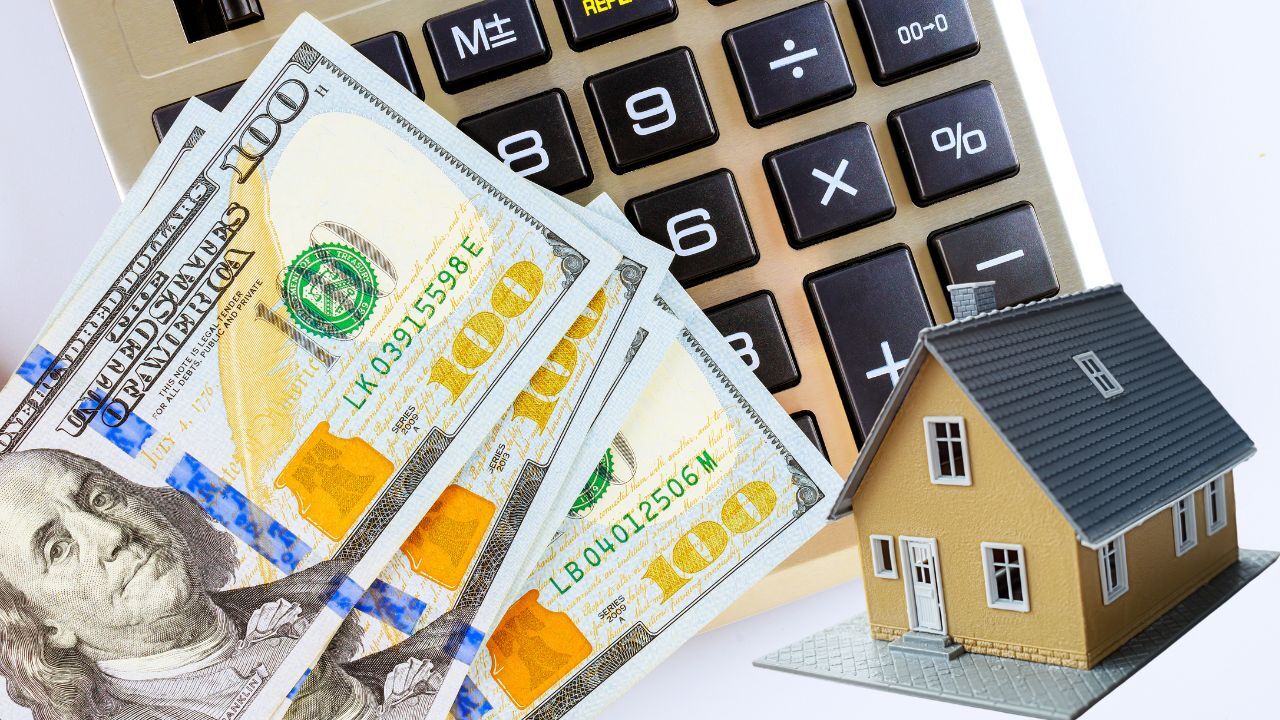 Photo of calculator, money, and house