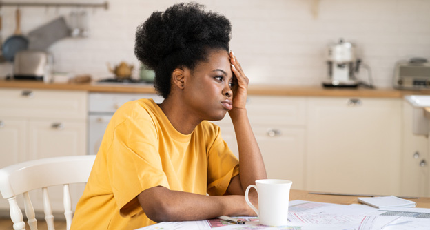 Lady sitting on table, showing concern
